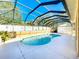 Inviting kidney-shaped pool with screened enclosure at 305 W Lady Lake Blvd, Lady Lake, FL 32159