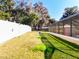 Side yard with grassy area and privacy fence at 305 W Lady Lake Blvd, Lady Lake, FL 32159