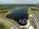 Aerial view of the water park at lake with wakeboarding cables and obstacles at 3150 Voyager Ave, St Cloud, FL 34771