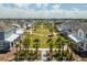 Aerial view of a neighborhood park featuring a grassy lawn and playground amidst the residential homes at 3150 Voyager Ave, St Cloud, FL 34771