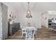 Bright dining room with a farmhouse table and gray wood buffet at 3259 Markward Dr, The Villages, FL 32163