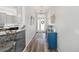 Hallway with blue console table and hardwood floors at 3259 Markward Dr, The Villages, FL 32163