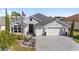 Two-story house with a large driveway and landscaped yard at 3259 Markward Dr, The Villages, FL 32163