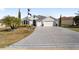 Two-story house with a large driveway and landscaped yard at 3259 Markward Dr, The Villages, FL 32163