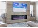 Modern electric fireplace with built-in seating and a large TV above at 3259 Markward Dr, The Villages, FL 32163
