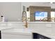 Modern kitchen sink with a gold faucet and white quartz countertop at 3259 Markward Dr, The Villages, FL 32163