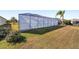 Spacious screened pool enclosure with a large backyard at 3259 Markward Dr, The Villages, FL 32163