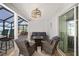 Relaxing screened porch with wicker furniture and fire pit at 3259 Markward Dr, The Villages, FL 32163