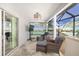 Outdoor lounge area with comfortable seating and tropical mural at 3259 Markward Dr, The Villages, FL 32163
