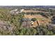 Aerial view of property showing house, sheds, and surrounding land at 3352 Ne 31St Ter, Wildwood, FL 34785