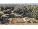 Aerial view of a house and surrounding property with trees and fences at 3352 Ne 31St Ter, Wildwood, FL 34785