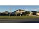 One-story home with landscaped yard, attached garage, and American flag at 3403 Rabbit Run Path, The Villages, FL 32163