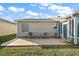 Backyard patio with seating area, offering a relaxing space at 3525 Idlewood Loop, The Villages, FL 32162