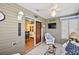 Sunroom with tiled floors, seating area, and sliding glass doors at 3525 Idlewood Loop, The Villages, FL 32162