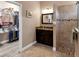 Bathroom with walk-in shower, granite vanity, and a large closet at 3809 Arlington Ridge Blvd, Leesburg, FL 34748