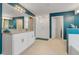 Spa-like bathroom with a walk-in shower and double vanity at 410 Cheeota Ct, Minneola, FL 34715