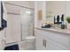 Bathroom with shower, vanity and blue towels at 410 Cheeota Ct, Minneola, FL 34715