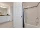 Bathroom with shower/tub combo and gray tile at 410 Cheeota Ct, Minneola, FL 34715