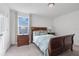 Charming bedroom with a sleigh bed and nightstand at 410 Cheeota Ct, Minneola, FL 34715