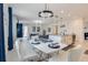 Modern dining area with white table and chairs at 410 Cheeota Ct, Minneola, FL 34715