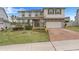 Two story house with stone and gray siding, two car garage at 410 Cheeota Ct, Minneola, FL 34715
