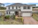 Two-story home with stone accents and a brick driveway at 410 Cheeota Ct, Minneola, FL 34715