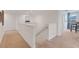 Upstairs hallway with staircase and carpeted flooring at 410 Cheeota Ct, Minneola, FL 34715
