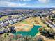 Aerial view of community, golf course, and pond at 4513 Antietam Creek Trl, Leesburg, FL 34748