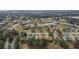 Aerial view of upscale neighborhood with houses and green spaces at 5072 Greens Dr, Lady Lake, FL 32159