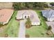 Aerial view of house, landscaping, and driveway at 5072 Greens Dr, Lady Lake, FL 32159