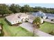 Single-Gathering home with a large yard and palm tree at 5072 Greens Dr, Lady Lake, FL 32159