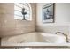 Relaxing bathroom with corner soaking tub and updated fixtures at 5072 Greens Dr, Lady Lake, FL 32159