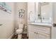 Powder room with glass vessel sink and white cabinets at 5072 Greens Dr, Lady Lake, FL 32159