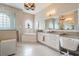 Elegant bathroom with a soaking tub, double vanity, and large mirror at 5072 Greens Dr, Lady Lake, FL 32159