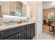 Double vanity bathroom with dark cabinets and granite counters at 5072 Greens Dr, Lady Lake, FL 32159