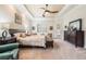 Spacious Primary bedroom with king-size bed, ample natural light, and large windows at 5072 Greens Dr, Lady Lake, FL 32159