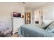 Main bedroom with dresser, light blue bedding, and ensuite bath at 5072 Greens Dr, Lady Lake, FL 32159