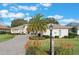 Single-Gathering home with paved driveway and landscaping at 5072 Greens Dr, Lady Lake, FL 32159