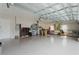Spacious garage with ample storage shelving and flooring at 5072 Greens Dr, Lady Lake, FL 32159