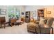 Bright home office features built-in shelving and comfortable seating at 5072 Greens Dr, Lady Lake, FL 32159