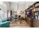 Home office with built-in shelving and hardwood floors at 5072 Greens Dr, Lady Lake, FL 32159