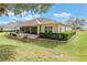 Single story home with lush landscaping and screened porch at 5072 Greens Dr, Lady Lake, FL 32159