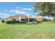 Single-story home with a large backyard and screened patio at 5072 Greens Dr, Lady Lake, FL 32159