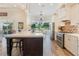 Open concept kitchen with island, stainless steel appliances and view to backyard at 5072 Greens Dr, Lady Lake, FL 32159