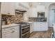 Modern kitchen featuring stainless steel appliances and white cabinetry at 5072 Greens Dr, Lady Lake, FL 32159