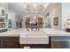 Kitchen island with a farmhouse sink and white quartz countertop at 5072 Greens Dr, Lady Lake, FL 32159