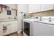 Laundry room with washer, dryer, and ample storage at 5072 Greens Dr, Lady Lake, FL 32159