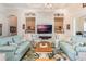 Living room featuring a stone fireplace and a stylish chandelier at 5072 Greens Dr, Lady Lake, FL 32159