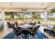 Cozy screened-in porch with outdoor furniture and tranquil backyard views at 5072 Greens Dr, Lady Lake, FL 32159