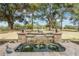 Serene water fountain with stonework detail in backyard at 5072 Greens Dr, Lady Lake, FL 32159